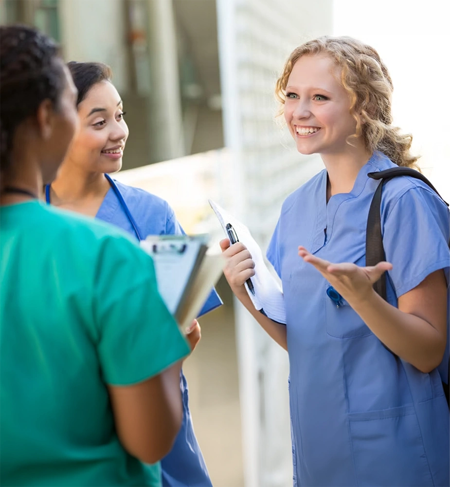 Group of nursing students talking in a hallway, representing nursing school reviews and nursing school evaluations for top-rated nursing programs.